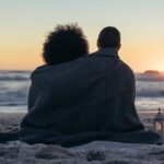 Couple admiring the sunset from beach